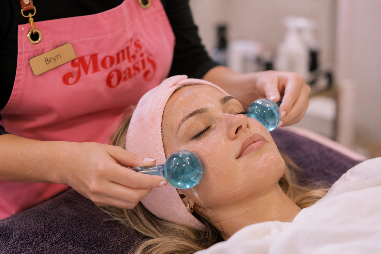 Woman receiving a sensitive skin facial with cooling globes at Mom’s Oasis spa in American Fork, Utah