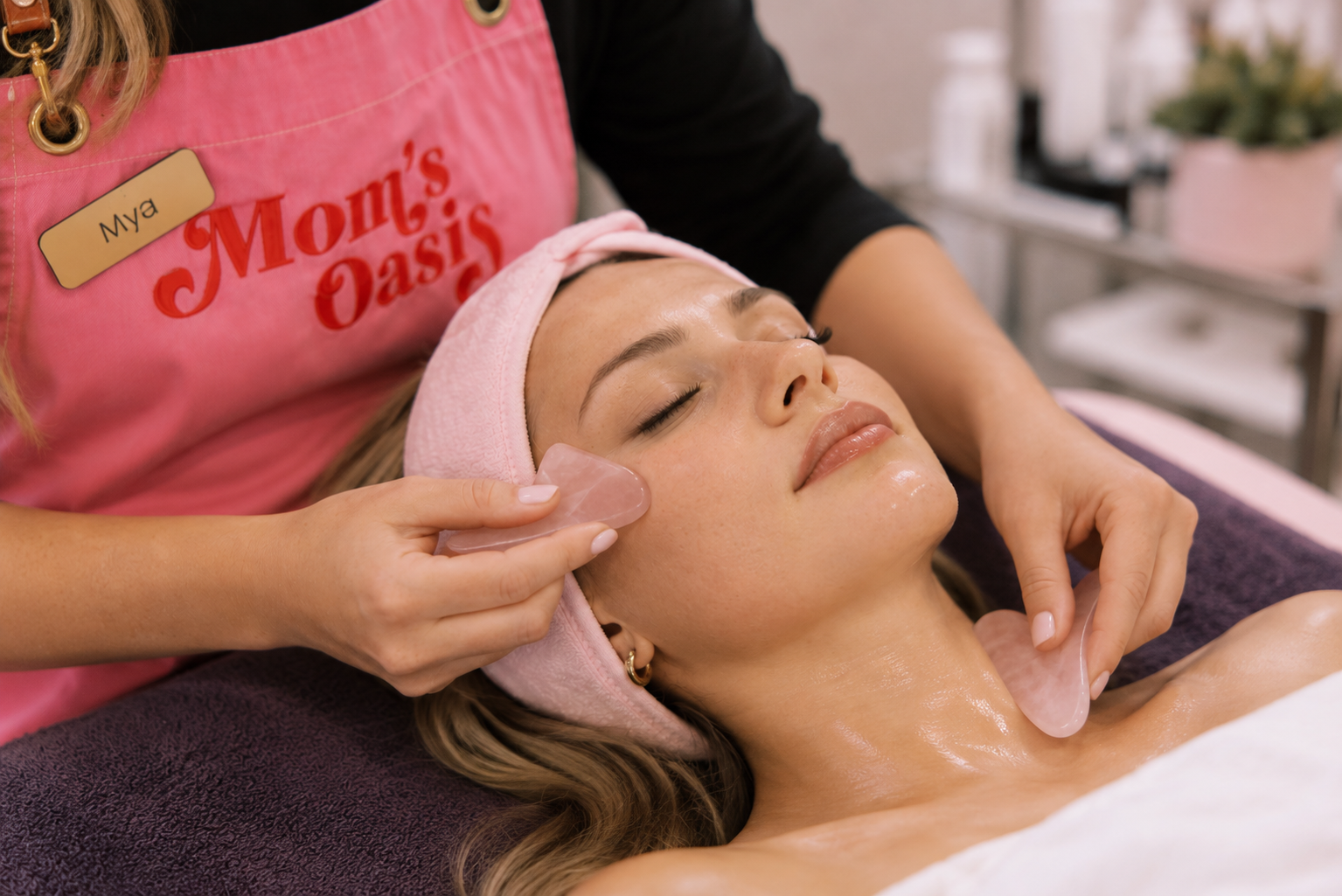 Woman receiving an age-defying facial with gua sha face and neck massage at Mom’s Oasis spa in American Fork, Utah